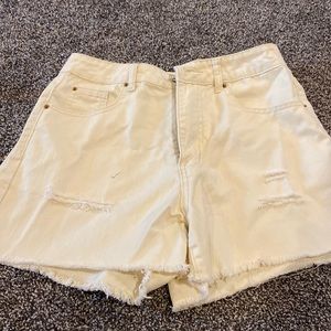 Women’s jean shorts with a few slits. SZ Medium. NEVER WORN